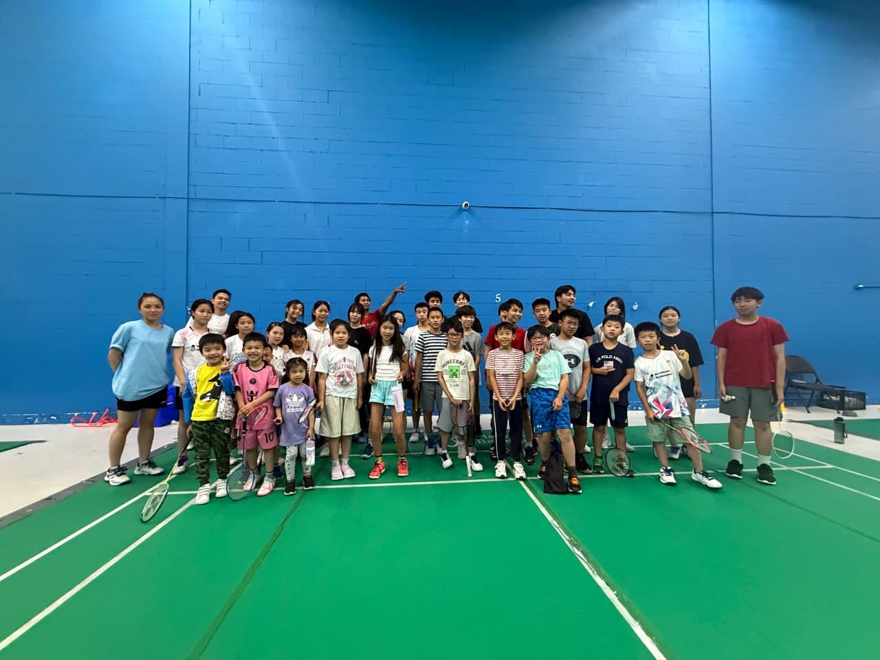 Summer badminton camp participants on court