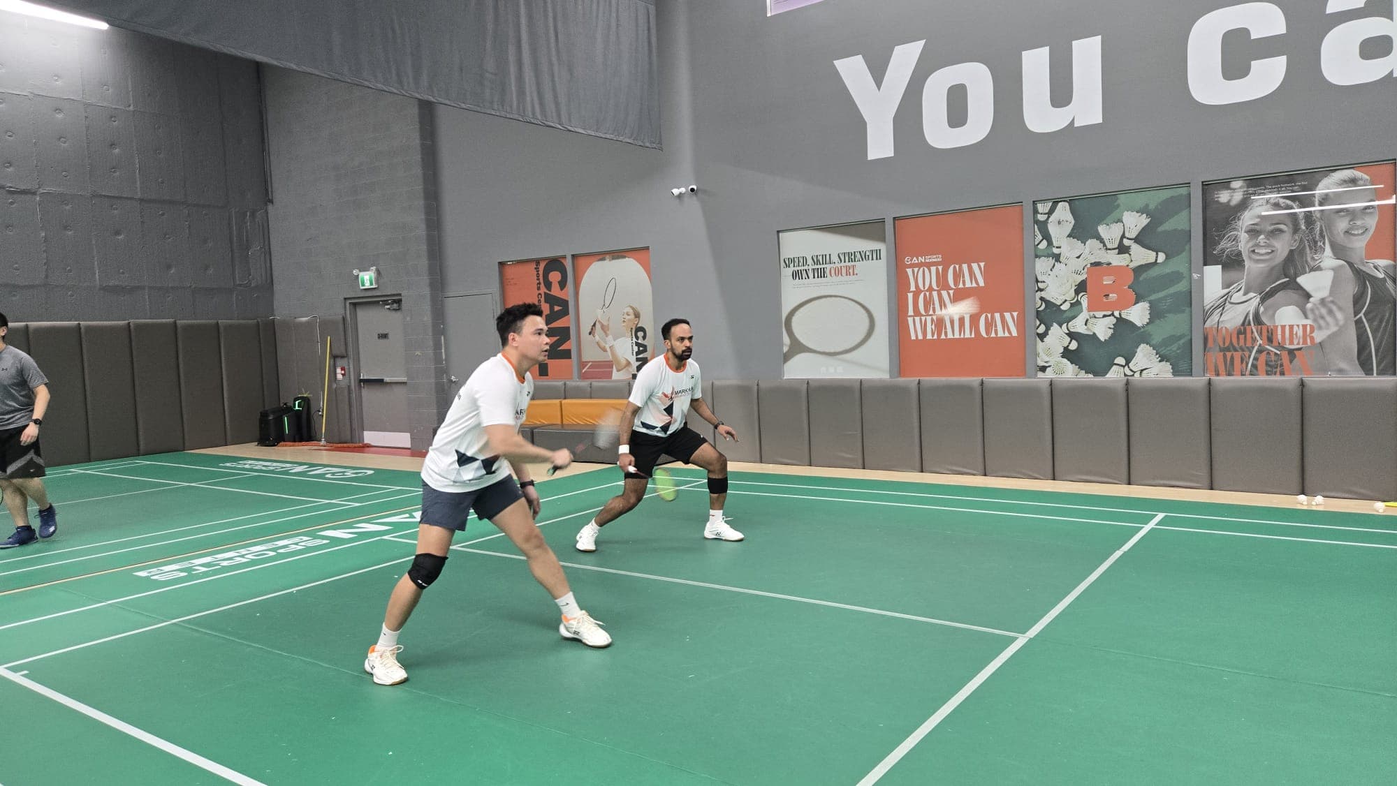 KMAX players preparing to receive during doubles league play